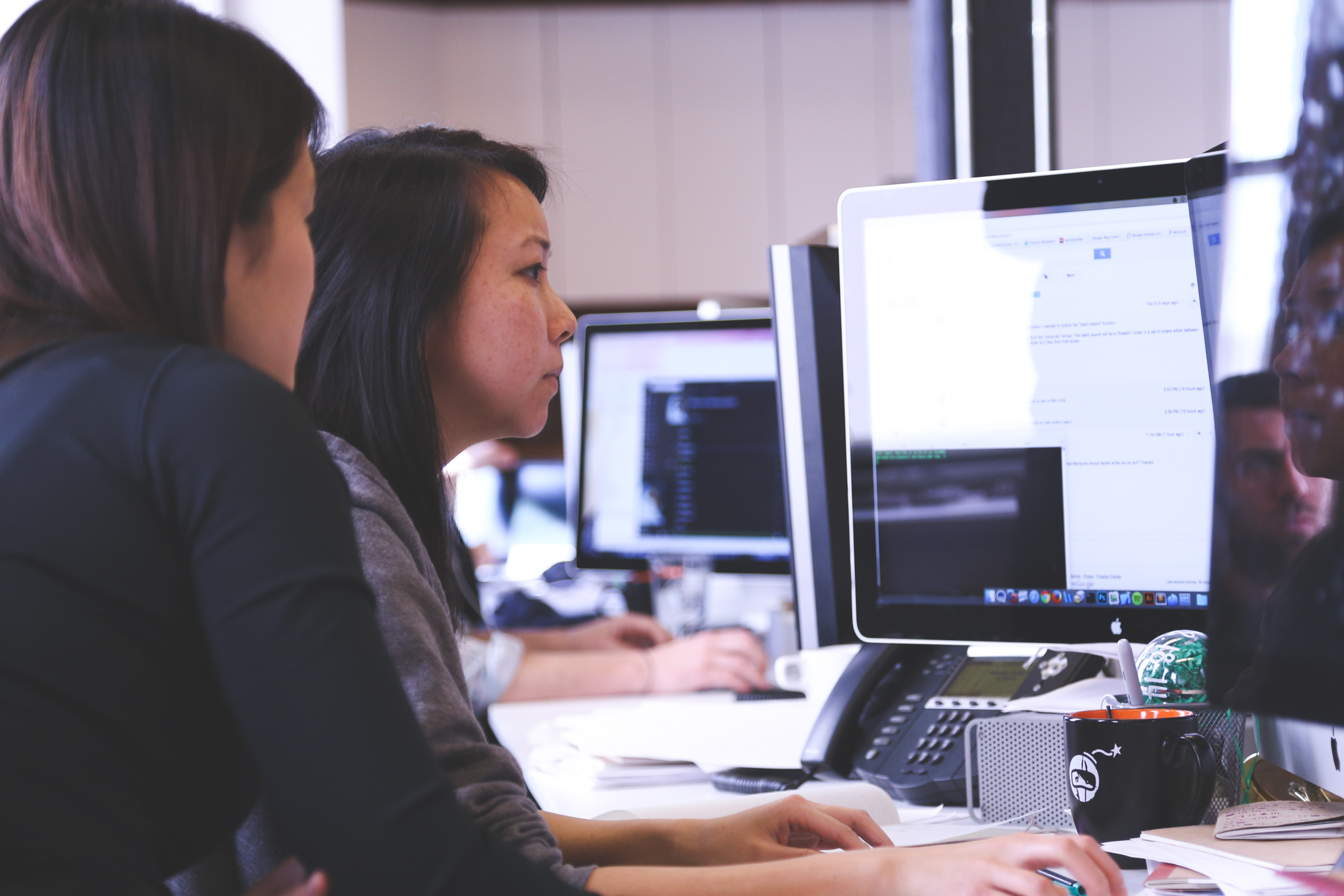 Two women at desk in office